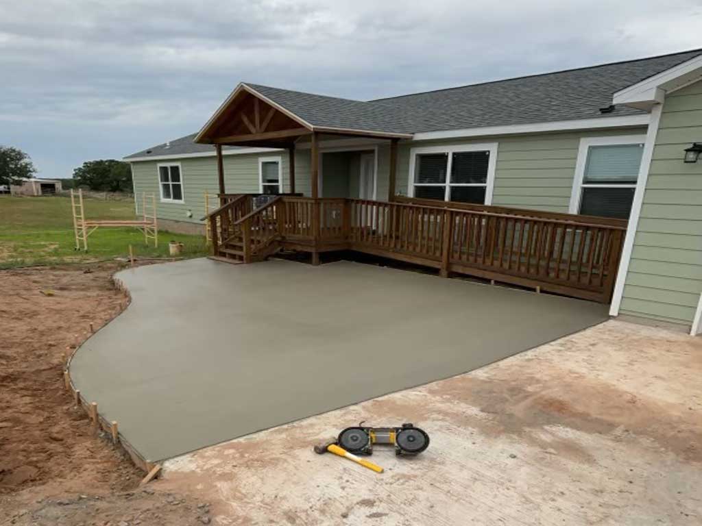 New concrete addition to driveway and porch deck